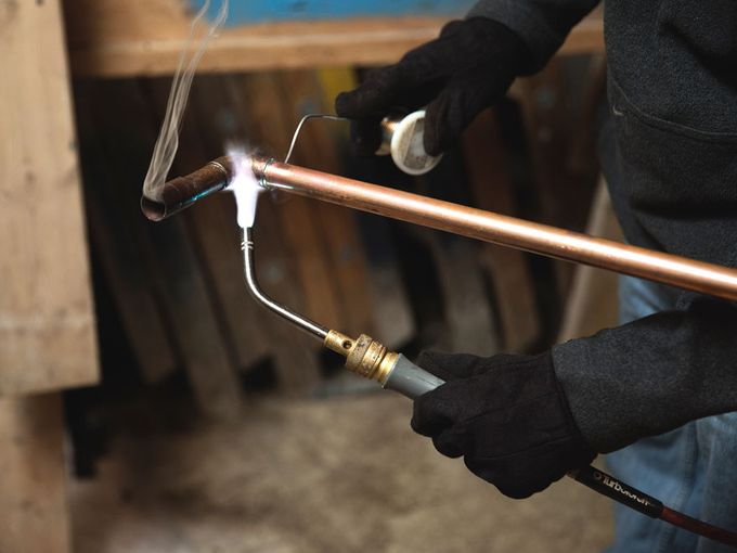 Benkari plumber working on piping installation